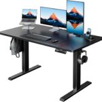 HUANUO 48″ x 24″ Electric Standing Desk Adjustable Height, 4 Memory Height Settings, Headphone Hook, Cable Manager, Sit Stand Up Desk for Home Office & Computer Workstation, Black